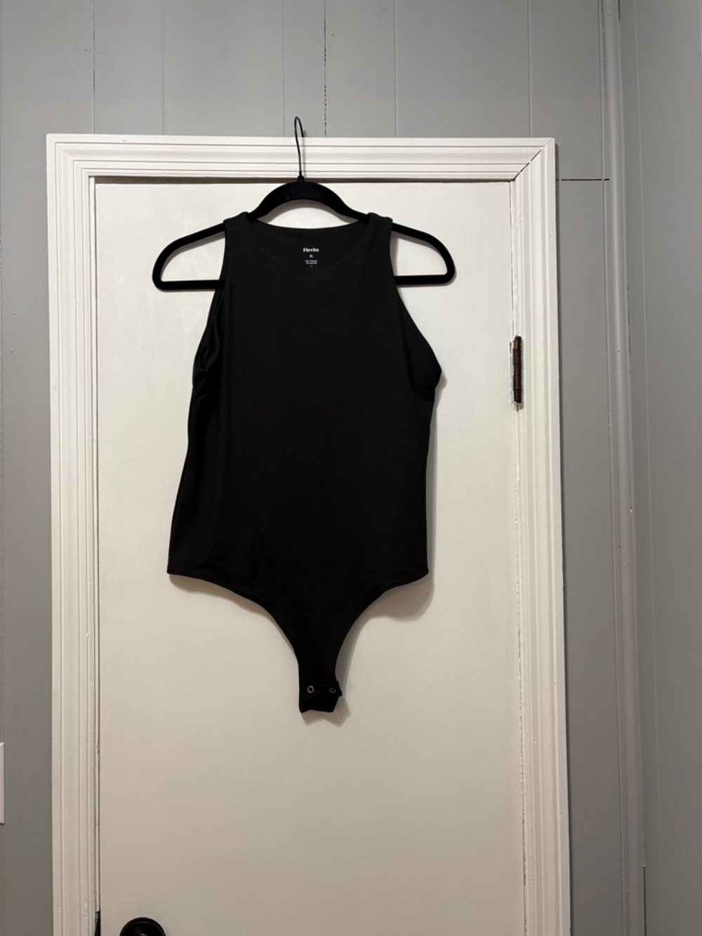 Sleeveless Black Ribbed Bodysuit with Snap Closure